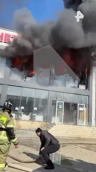 Пламя вырывается из окон торгового центра в дагестанском Кизляре, где произошел сильный пожар
